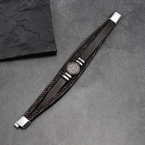 Detailed view of multilayer leather bracelet with a vintage silver Viking compass charm