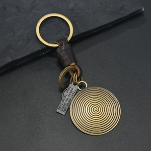 Vintage bronze ginkgo leaf keychain with brown braided leather strap and engraved metal plate