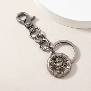 Close-up of vintage silver alloy wheel keychain with hexagonal star and lobster clasp