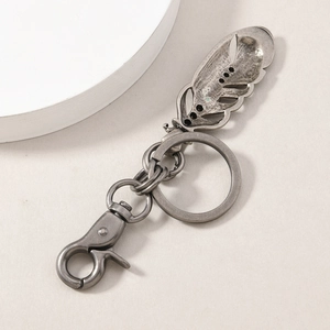 Vintage silver alloy keychain featuring a feather pendant, flat ring, and lobster clasp