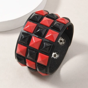 Detail view of triple-row pyramid rivet punk leather bracelet with snap closures