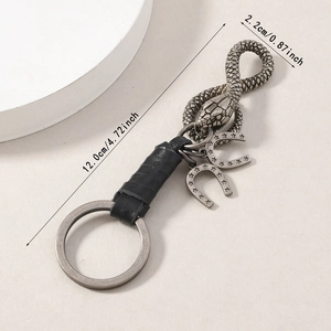Vintage horseshoe keychain with hand-woven leather and carved snake head pendant