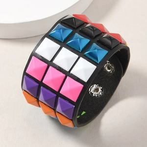 Macro view of punk leather bracelet with colorful pyramid studs and snap buttons
