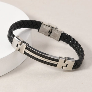 Macro detail of men's leather braided bracelet with stainless steel cable inlay