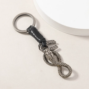 Vintage horseshoe and snake keychain with hand-woven black leather and antique silver metal