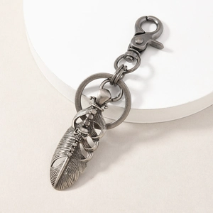 Vintage silver skull and feather metal keychain with rotating spring hook and ring