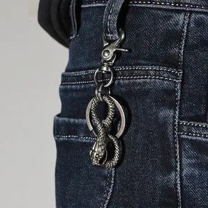 Vintage silver snake alloy keychain with detailed scale texture and lobster clasp on denim