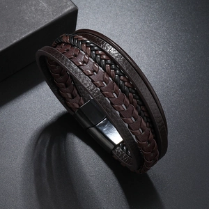Detailed macro view of multilayer braided leather bracelet with black magnetic metal clasp