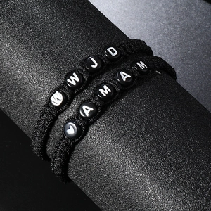 Adjustable woven black rope bracelet set with white letter beads featuring WWJD and IAMAM