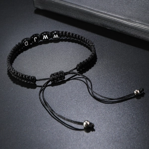 Adjustable black woven rope bracelet featuring letter beads and silver metal accents