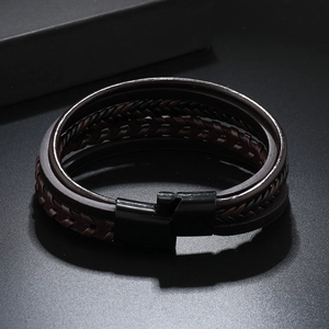 Detail of multi-layer hand-woven leather bracelet with matte black magnetic buckle