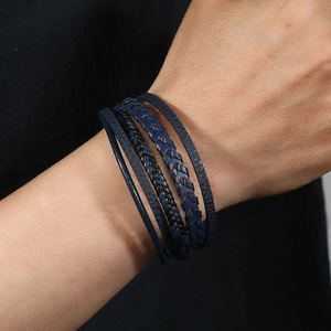 Detail of men's multi-layer braided leather bracelet with blue and black textures