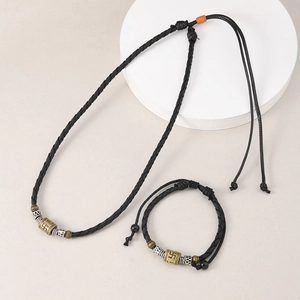 Macro shot of Tibetan vintage swastika beads on adjustable black braided cord necklace