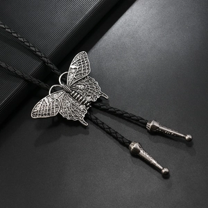 Close-up of vintage silver butterfly bolo tie with black braided leather and metal tips