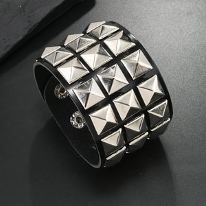 Detail view of black punk leather bracelet with triple rows of silver pyramid studs