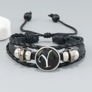 Close-up of multilayer leather bracelet with silver beads and letter Y charm