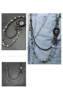 Detail of punk double-layer waist chain with metal dice charms on light blue denim jeans
