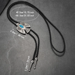 Macro detail of vintage eagle bolo tie with turquoise stone and braided leather cord length