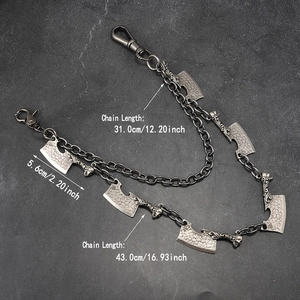 Detail of punk silver double-layer trousers chain with knife charms and skull pendants