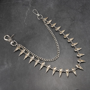 Detail of double-layer punk waist chain with metal cone spikes and heavy silver links
