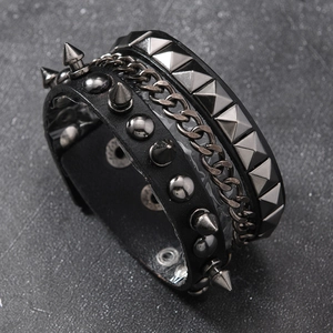 Punk leather bracelet with spikes and metal chain details for rock fashion style