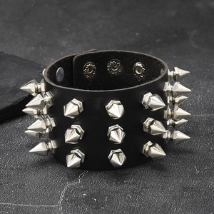 Punk rock style wide black leather bracelet featuring three rows of silver metal spikes