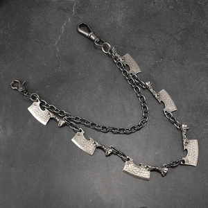 Close-up of double-layer punk waist chain featuring skull and cleaver pendants