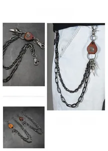Detail of punk style multi-layer metal pants chain featuring eagle leather charm on jeans