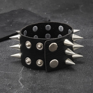 Detail of a punk black leather bracelet with triple rows of silver metal spikes