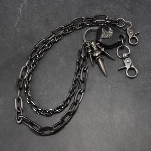 Detail view of gunmetal punk pants chain with eagle leather patch and metal spikes