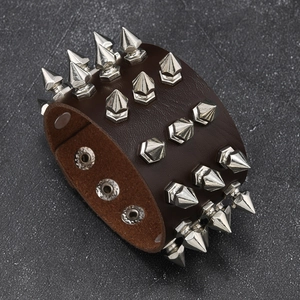 Detailed side view of punk brown leather bracelet with four rows of silver cone studs