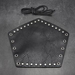 Close-up of black snake pattern faux leather arm guard with rivets and lacing