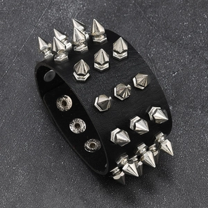 Detail view of the punk black leather bracelet with four rows of silver metal spikes