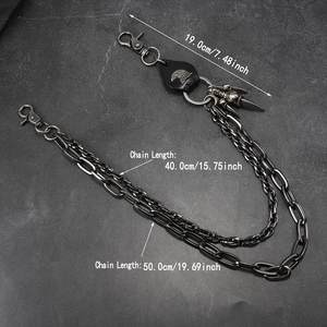 Detail view of punk wallet chain with eagle head leather tag and metal dagger pendant