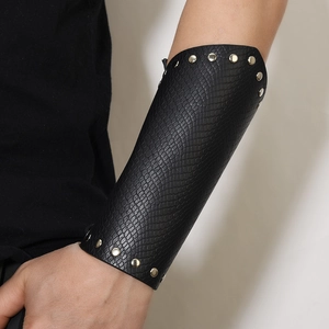 Adjustable black faux leather forearm guard with silver rivets and snake texture