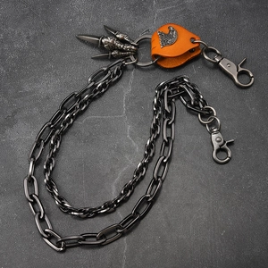 Detail of punk style double-layered waist chain with eagle head leather and claw pendant