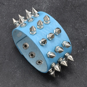 Detail view of sky blue punk leather bracelet with three rows of silver metal cone spikes