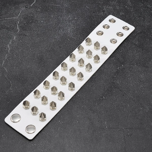 Detail of white PU leather punk bracelet featuring three rows of silver metal rivets