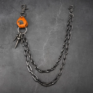 Detail of gunmetal punk chain with eagle embossed leather patch and conical pendants