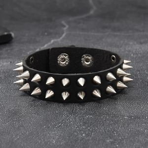 Detailed close-up of punk black leather bracelet with sharp double-row silver metal rivets