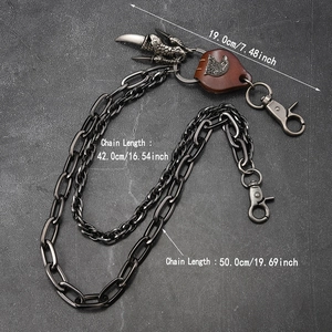 Detail of punk trousers chain with eagle leather patch and claw pendant on stone