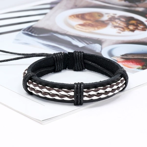 Bracciale multistrato in pelle intrecciata da uomo in stile retrò su sfondo rivista