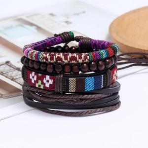 Macro shot of bohemian layered bracelet set with woven bands and dark wood beads