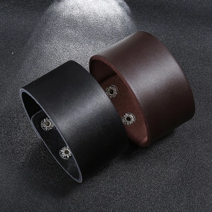 Punk style wide leather bracelets in black and dark brown with metal snap buttons