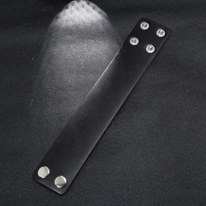 Punk black wide leather bracelet for men with adjustable silver snap buttons on grey background