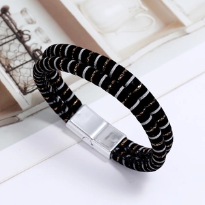 Close-up of double-wrap leather bracelet with silver magnetic clasp and metallic stripes