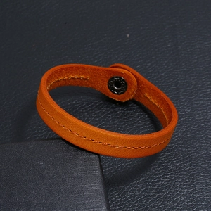 Punk orange genuine leather bracelet with yellow stitching and black metal snap button
