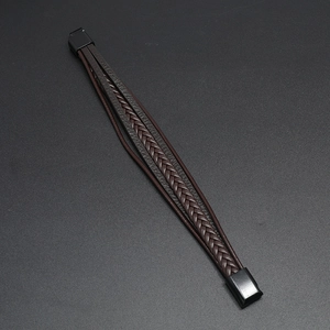 Macro detail of multilayer woven leather bracelet with matte black magnetic metal clasp