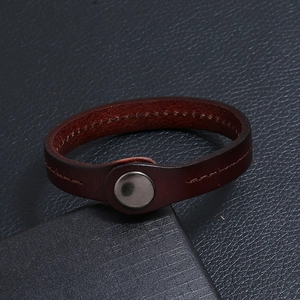 Minimalist punk style dark brown leather bracelet with stitching and metal snap button