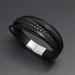 Close-up of multi-layer black braided leather bracelet with silver magnetic metal clasp